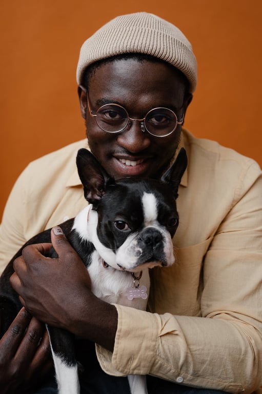 Black male in glasses with dog